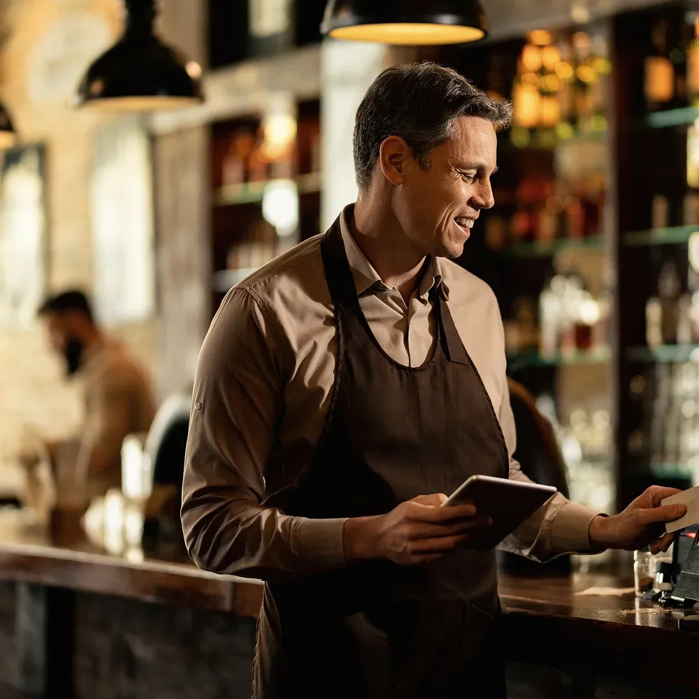 A female bar worker pulling a pint