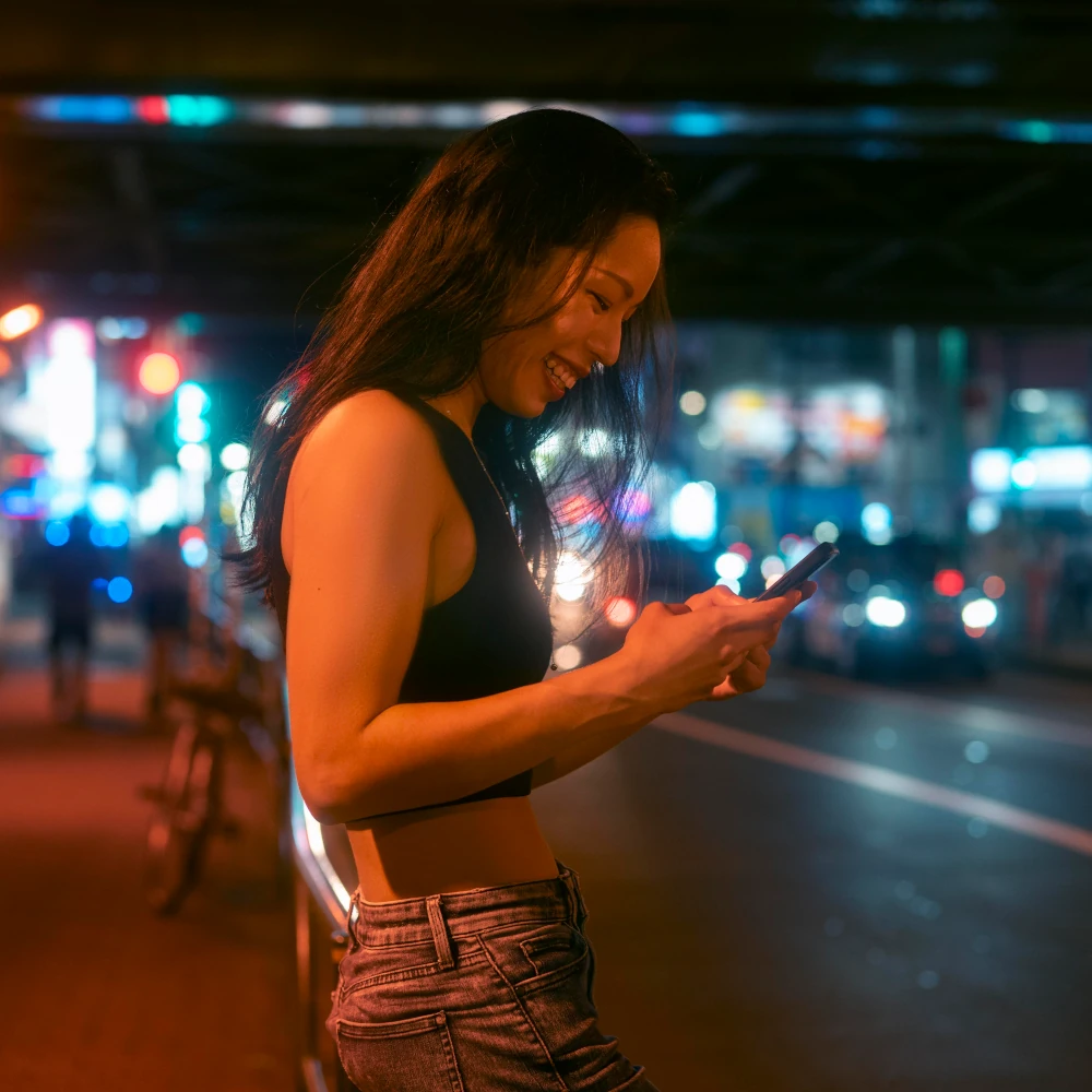 A woman booking tickets for a nightclub event on her mobile phone